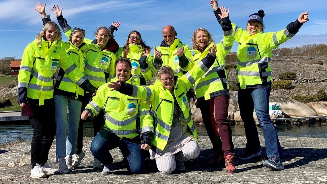 Alle ansatte i selskapet i gule refleksjakker og glade ansikter